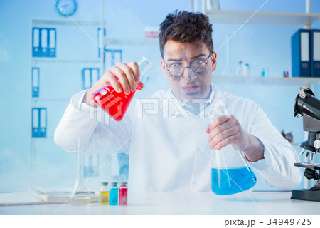 Funny mad chemist working in a laboratory 34949725