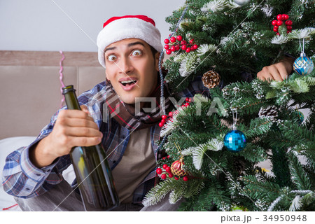 Man suffering hangover after christmas party 34950948