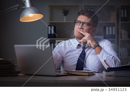 Businessman under stress smoking in office Businessman under stress smoking in office 34951123