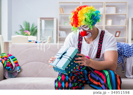 Drunk clown celebrating having a party at home Drunk clown celebrating having a party at home 34951598