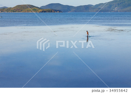 Fishermen are fishing at a lagoon in Phuoc Dong Fishermen are fishing at a lagoon in Phuoc Dong 34955642