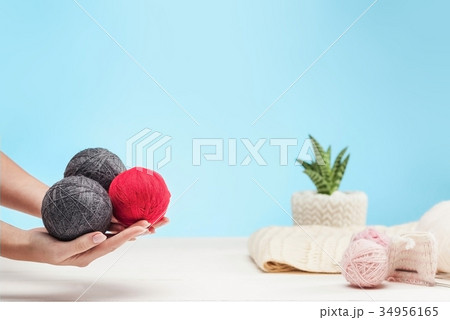 The balls of wool on white wooden background The balls of wool on white wooden background 34956165