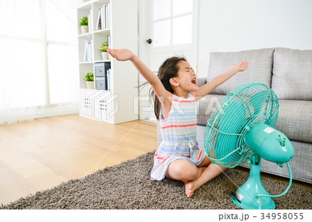 young girl children sitting on living room floor 34958055