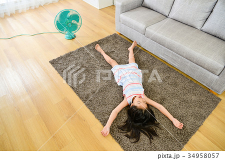 high angle view photo of girl lying down on carpet 34958057