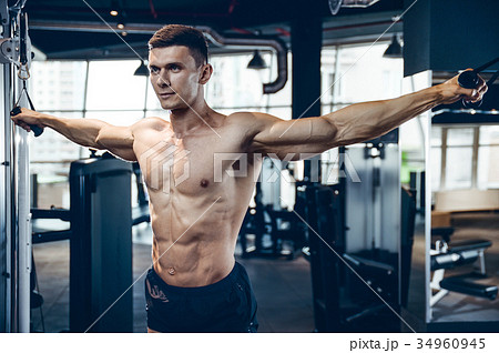 Brutal Caucasian bodybuilder training chest in gym Brutal Caucasian bodybuilder training chest in gym 34960945