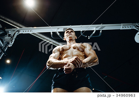 Handsome model young man working out in gym Handsome model young man working out in gym 34960963