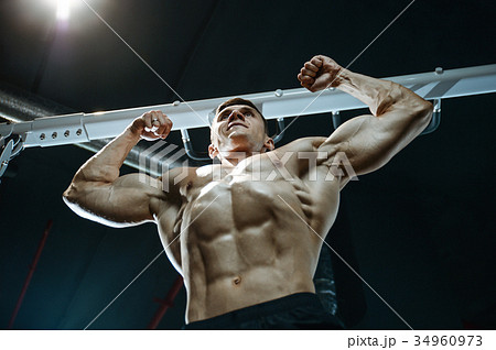 Handsome model young man working out in gym 34960973