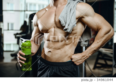 Handsome model young man working out in gym 34961044