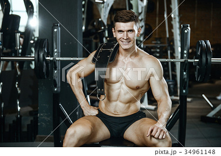 Handsome model young man working out in gym 34961148