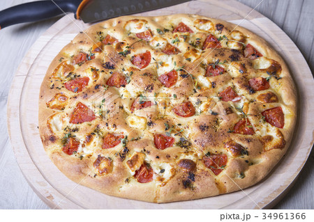 Fresh bread focaccio with cheese and tomatoes Fresh bread focaccio with cheese and tomatoes 34961366