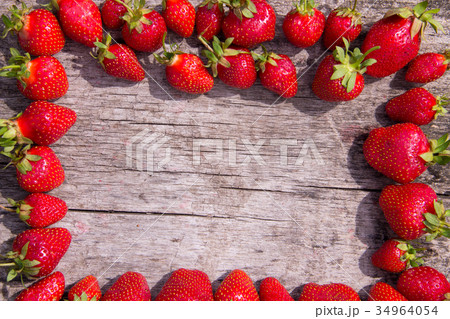 Frame of fresh red strawberries on wooden tabletop 34964054