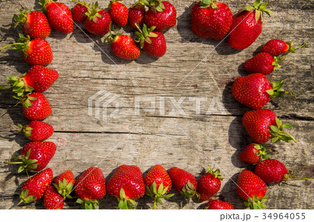 Frame of fresh red strawberries on wooden tabletop Frame of fresh red strawberries on wooden tabletop 34964055