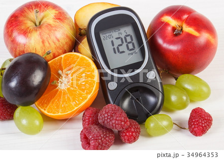 Glucometer and fresh fruits, diabetes Glucometer and fresh fruits, diabetes 34964353