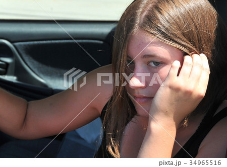 Female driving new car. 34965516