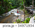 Woman tourism standing on little waterfall,stream 34971934