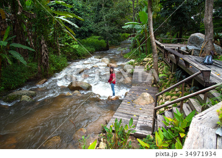 Woman tourism standing on little waterfall,stream 34971934
