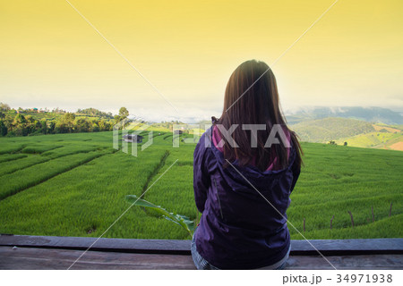 Woman tourism sitting on wood balcony to see view 34971938