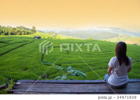 Woman tourism sitting on wood balcony to see view 34971939