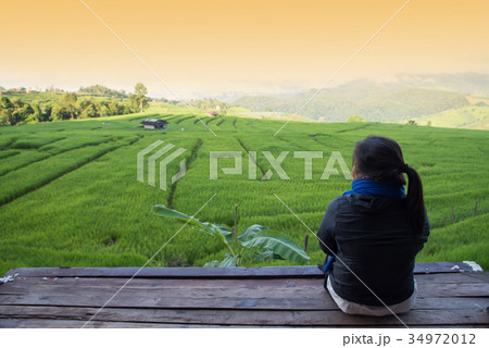 Woman tourism sitting on wood balcony to see view 34972012