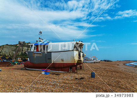 Fishing boats on the shore, pebble beach 34973983