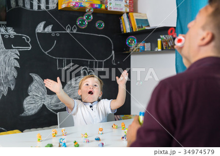 Cute little toddler boy at speechtherapist session 34974579