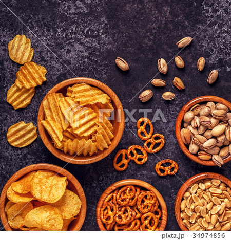 Snacks in a bowls on stone background. Snacks in a bowls on stone background. 34974856