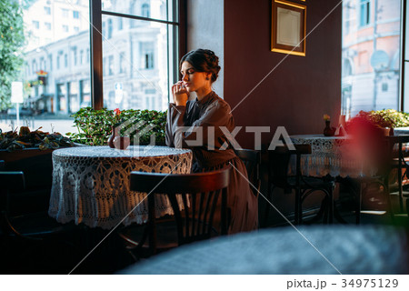 Young beautiful retro lady in cafe 34975129