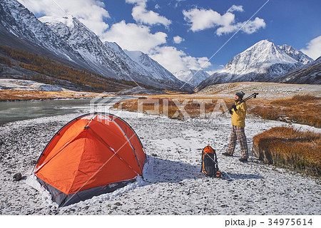 Hiker with backpack at camping in the mountains Hiker with backpack at camping in the mountains 34975614