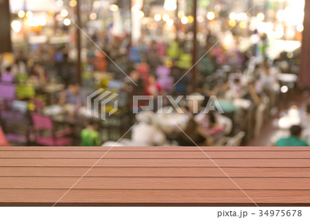 Wooden table with blur restaurant background Wooden table with blur restaurant background 34975678
