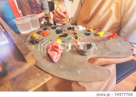 Scaled up view on artist mixing bright paints on Scaled up view on artist mixing bright paints on 34977788