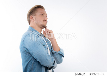 Young fair-haired man thinking about crucial 34979087