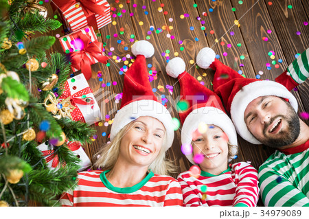 Happy family holding Christmas gift boxes 34979089
