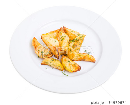 Baked potato wedges with minced dill. Baked potato wedges with minced dill. 34979674