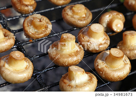 White champignons mushrooms on grill White champignons mushrooms on grill 34981673