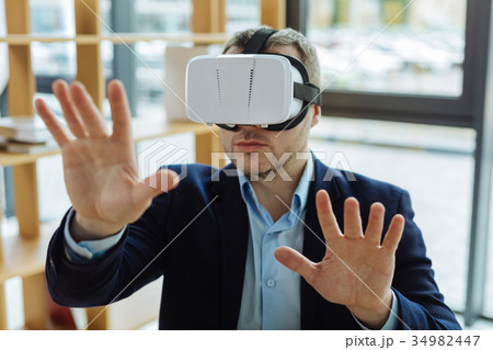 Serious adult man using 3d glasses Serious adult man using 3d glasses 34982447
