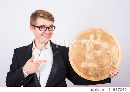 Happy cheerful young businessman holding big Happy cheerful young businessman holding big 34987246
