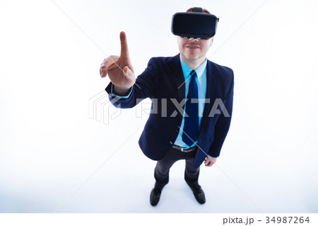 Cheerful positive businessman using modern 34987264