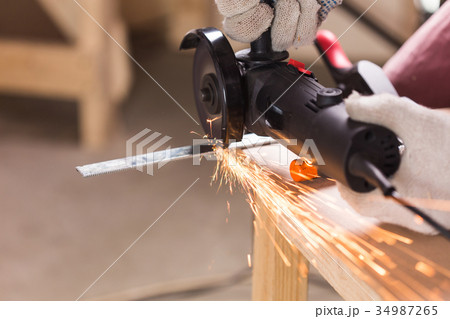 Heavy industry worker cutting steel with angle 34987265