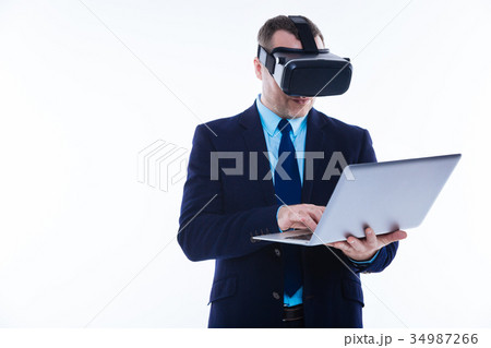 Nice handsome man holding a laptop Nice handsome man holding a laptop 34987266