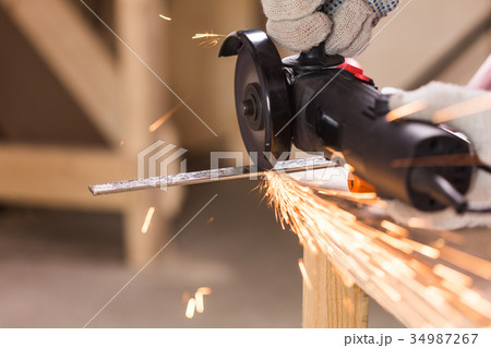 cutting metal with angle grinder, sparks from the cutting metal with angle grinder, sparks from the 34987267