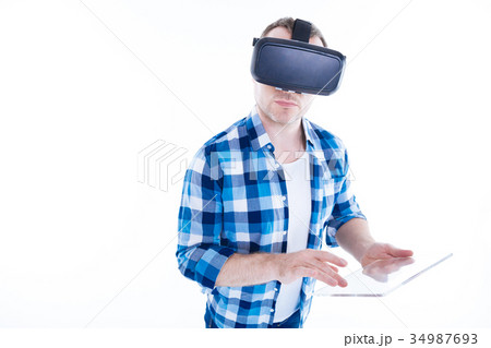 Confident smart man using a tablet Confident smart man using a tablet 34987693