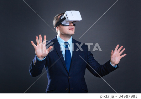 Nice handsome man experiencing virtual world 34987993