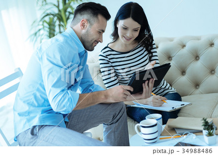 Pleasant successful people watching something on 34988486