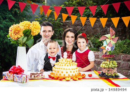 family of four people father mom son and daughter celebrates daughter's birthday three years family of four people father mom son and daughter celebrates daughter's birthday three years 34989494
