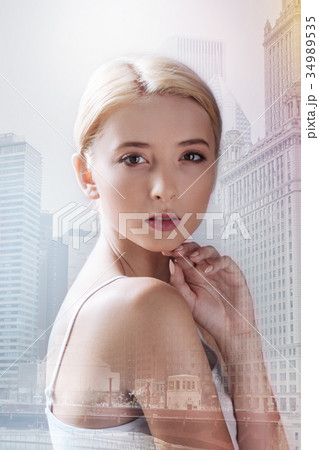 Beautiful model keeping her hand under the chin 34989535