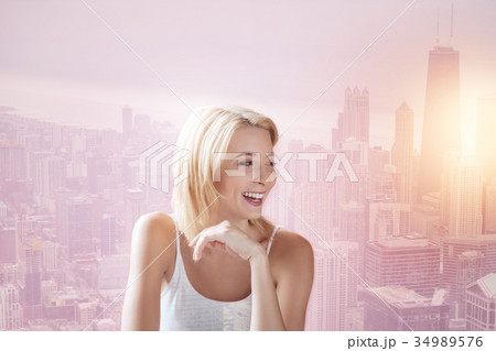 Pleasant girl looking away and laughing Pleasant girl looking away and laughing 34989576