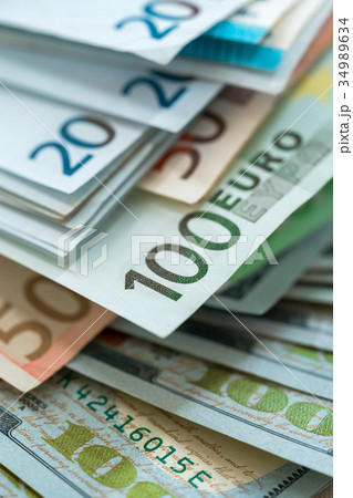 Euro and USA dollar money banknotes background Euro and USA dollar money banknotes background 34989634