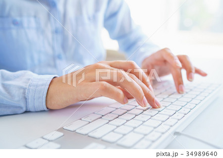 Female woman office worker typing on the keyboard Female woman office worker typing on the keyboard 34989640