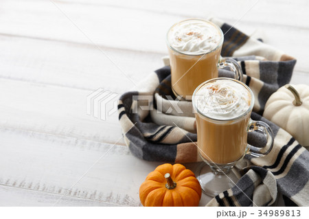 Fall pumpkin spice latte with whipped cream on white wooden background Fall pumpkin spice latte with whipped cream on white wooden background 34989813