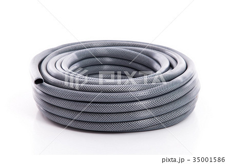 curled garden hose isolated on white 35001586